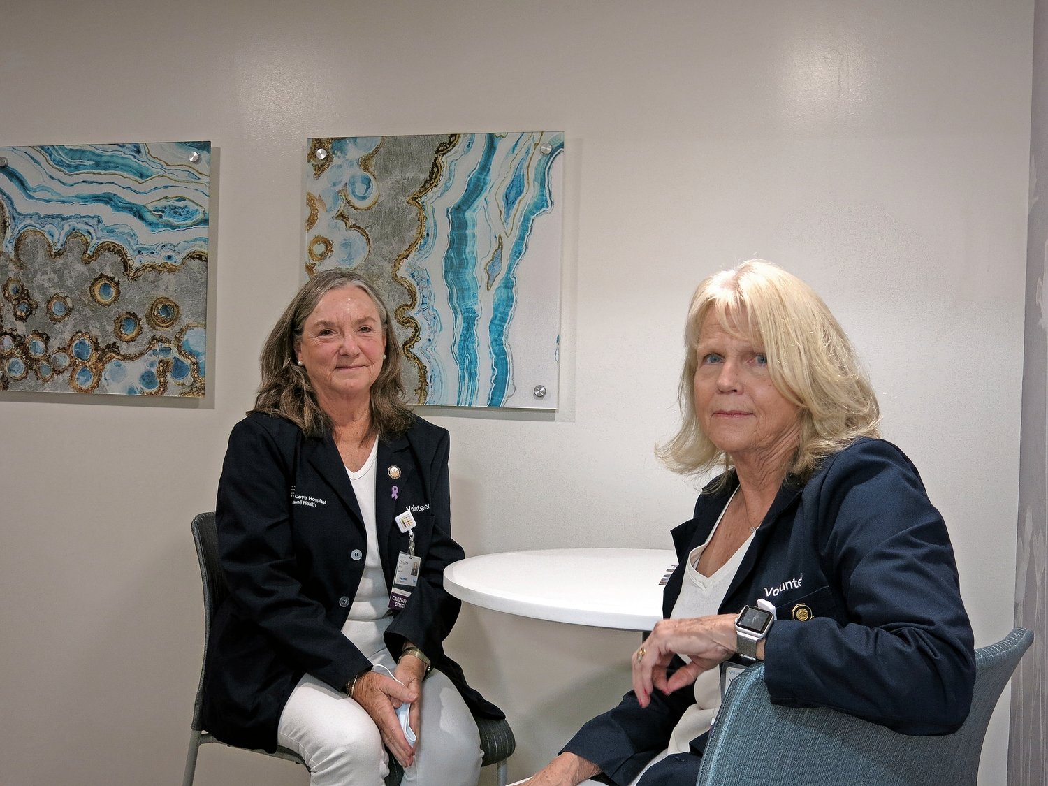 Christine Mills, far left, and Nancy White, in one of the rooms at the Caregiver Center, say their work as volunteer caregiver coaches at Glen Cove Hospital is rewarding.
